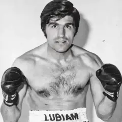 Boxer Nino Benvenuti, a powerful figure with boxing gloves on, ready to fight.