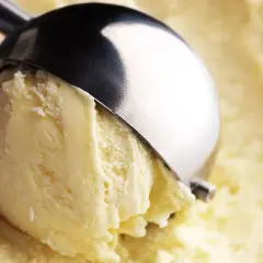 Un cucchiaio raccoglie un cremoso gelato, con un sapore che ricorda il latte condensato.