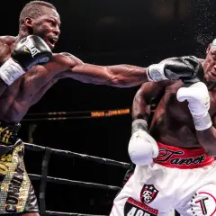 Two boxers exchange blows in the ring. The boxer on the left lands a punch, while the boxer on the right braces for impact. This intense fight showcases the power and skill involved in boxing, where weight classes like cruiserweight define the competit...