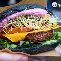 Deliciosa hamburguesa vegetal con pan negro, queso fundido, aguacate, tomate, brotes y una cremosa salsa rosa. ¡Una explosión de sabor!