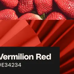 Juicy strawberries and a vibrant vermilion red flower, showcasing the rich hue.