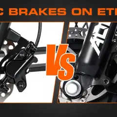 Close-up comparison of hydraulic brakes vs disc brakes on an e-trike, highlighting their distinct mechanisms for powerful stopping.