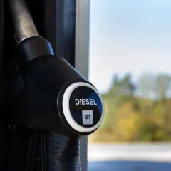 Dystrybutor paliwa z oznaczeniem DIESEL B7. W tle jesienne drzewa i błękitne niebo.