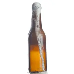 Bière débordant d'une bouteille, la mousse blanche montant. Le pourcentage d'eau dans la bière est élevé, comme le montre cette effervescence.