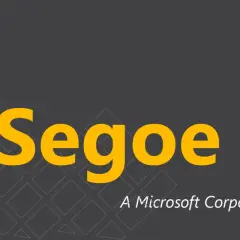 Segoe UI, czcionka Microsoftu, prezentowana na ciemnoszarym tle z geometrycznym wzorem.