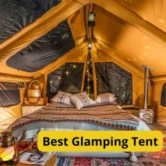Wnętrze luksusowego namiotu glampingowego z wygodnym łóżkiem, piecykiem i nastrojowym oświetleniem. To jest właśnie glamping co to znaczy – komfort na łonie natury.