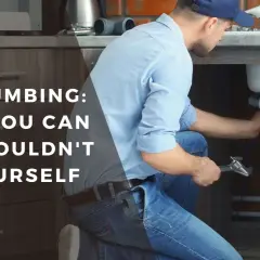 Man working on sink plumbing, part of a DIY bathroom remodel guide.
