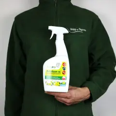 Osoba w zielonej bluzie trzyma butelkę z opryskiem Betokson AL. Produkt poprawia zawiązywanie owoców.
