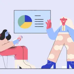 Dwie kobiety omawiają wyniki badań na ADHD. Jedna siedzi, druga stoi, wskazując na wykres.