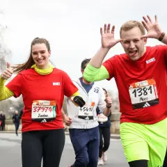 Joyeux coureurs au semi-marathon Paris 2026, une femme fait un pouce levé, un homme fait des grimaces.