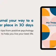 Tablet displaying "my happy place" journal, a positive psychology-based guide. Text promotes journaling for happiness.