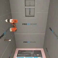 Drill in hand, ready to install concrete board for a shower. This image shows the process of how to install concrete board, with the PROVA BOARD brand visible.
