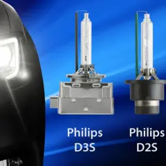 Reflektor samochodu z włączonym światłem ksenonowym obok żarówek Philips D3S, D2S i D8S.