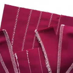 Swatches of magenta fabric show various stitch types, demonstrating adjusting tension on a sewing machine for different seam finishes.