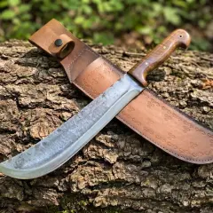 Machete de hoja ancha y mango de madera, con funda de cuero grabada. Descubre su machete precio.