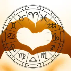 Dłonie tworzą serce w kole zodiaku. Sprawdź horoskop na przyszły tydzień dla Bliźniąt i odkryj swój los.