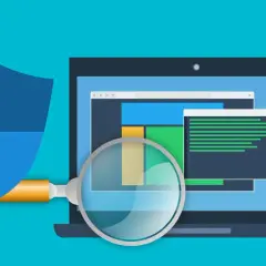 Bouclier bleu protégeant un ordinateur portable analysé par une loupe. Illustration sur la façon de se débarrasser du ransomware.