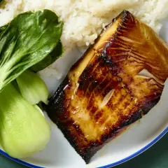 A perfectly seared miso cod recipe served with fluffy white rice and vibrant green bok choy.