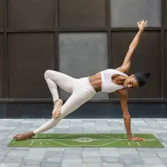 A woman in yoga attire performs a challenging pose on a mat, demonstrating how to block a hook with core strength and balance.