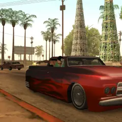 Ucieczka w San Andreas. Czerwony wóz z płomieniami pędzi ulicą, podczas gdy gang ucieka przed policją.