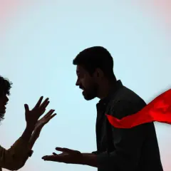 Coppia in silhouette che litiga, con una bandiera rossa che sventola, simbolo di un avvertimento.