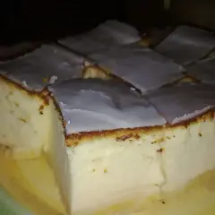 Puszysty sernik, który każdemu wychodzi, pokrojony w kostkę i polany lukrem. Idealny na deser.