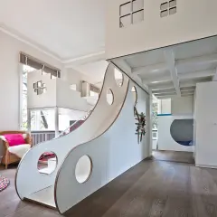 Ein fantasievolles Kinderzimmer mit Rutsche und Spielhaus. Hier können 3 Kinder nach Herzenslust spielen und toben.