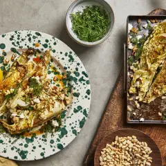 Ugnsbakad spetskål i soja, toppad med fetaost, pinjenötter och dill. Serveras med citronklyfta.