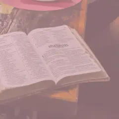 Otwarta księga z tekstem biblijnym, obok notatki ręczne. Wszystko to przypomina o marności nad marnościami, przemijaniu.