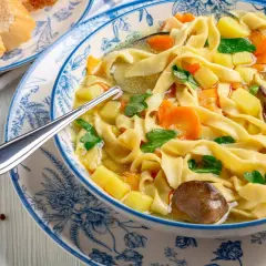 Domowy rosół z lanymi kluskami, przepis babci. Aromatyczna zupa z makaronem, marchewką i ziemniakami.
