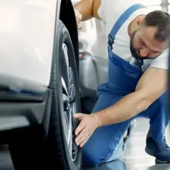 Mekaniker undersöker ett hjul på en VW Amarok, kanske ett vw amarok problem som behöver åtgärdas.