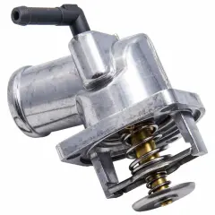 Metalowy termostat w samochodzie z widocznym mechanizmem sprężynowym i czarną złączką.