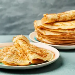 Gestapelte Pfannkuchen auf Tellern, bereit für ein köstliches Pfannkuchen Rezept.