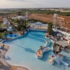 Aerial view of a water park with slides, pools, and a wave pool.