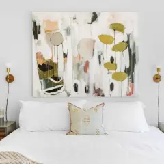 Staging a master bedroom with a large abstract painting above a white bed, flanked by modern nightstands and sconces.