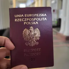 Dłoń trzyma polski paszport. Ważność paszportu jest kluczowa do podróży.