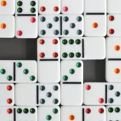 Klocki domino z kolorowymi kropkami, gotowe do gry. Poznaj zasady gry w domino i zacznij zabawę!