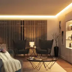 Mujer relajada en sofá con manta, rodeada de cálida iluminación ambiental de 3000k color.