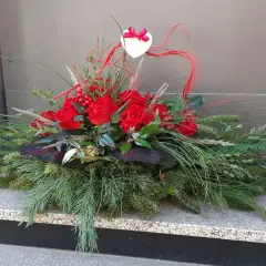 Wiązanki z róż na Wszystkich Świętych, ozdobione sercem i gałązkami iglaków, tworzą elegancką kompozycję.