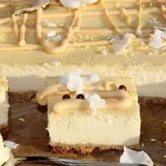 Pyszny sernik z mlekiem, udekorowany kremem, wiórkami kokosowymi i czekoladowymi kuleczkami. Idealny na deser.