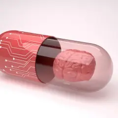 Czerwona kapsułka z obwodami drukowanymi zawiera mózg, symbolizując potencjalne leki, np. inhibitory MAO, wpływające na funkcje poznawcze.