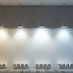 Lámparas colgantes iluminan una pared, mostrando una gama de temperaturas de color de cálido a frío, desde 1000K hasta 10000K.