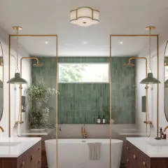 Elegant bathroom with dual vanities, a freestanding tub, and green tiled showers. Learn how to hang a bathroom mirror in this stylish space.