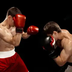 Two boxers spar intensely. The dedication shown hints at how many hours boxers train a day to reach this level of skill and conditioning.