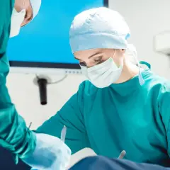 Chirurg wykonuje zabiegi dermatologiczne, skupiony na pracy.