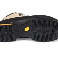 A black hiking boot with a tan upper, featuring a deep lugged Vibram sole designed to be non-slip for secure trekking.