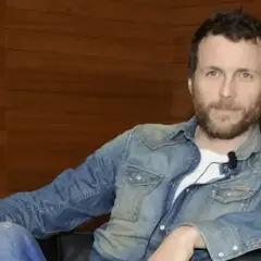 Jovanotti, con la sua camicia di jeans, sembra pronto a cantare "Mi fido di te".