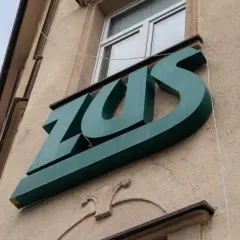 Zielone logo ZUS na budynku. Warto wiedzieć, jak wynagrodzenie chorobowe a składki ZUS wpływają na Twoje finanse.