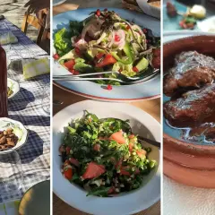 Pyszne jedzenie na Cyprze: sałatki, migdały, butelka wina i gulasz w glinianym naczyniu.