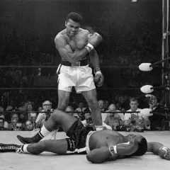 Muhammad Ali stands over a fallen opponent, embodying his famous quote to float like a butterfly and sting like a bee.